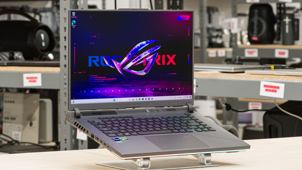 ASUS ROG Strix G16 gaming laptop with a vibrant display, RGB keyboard, and cutting-edge design, set up in a tech workspace.